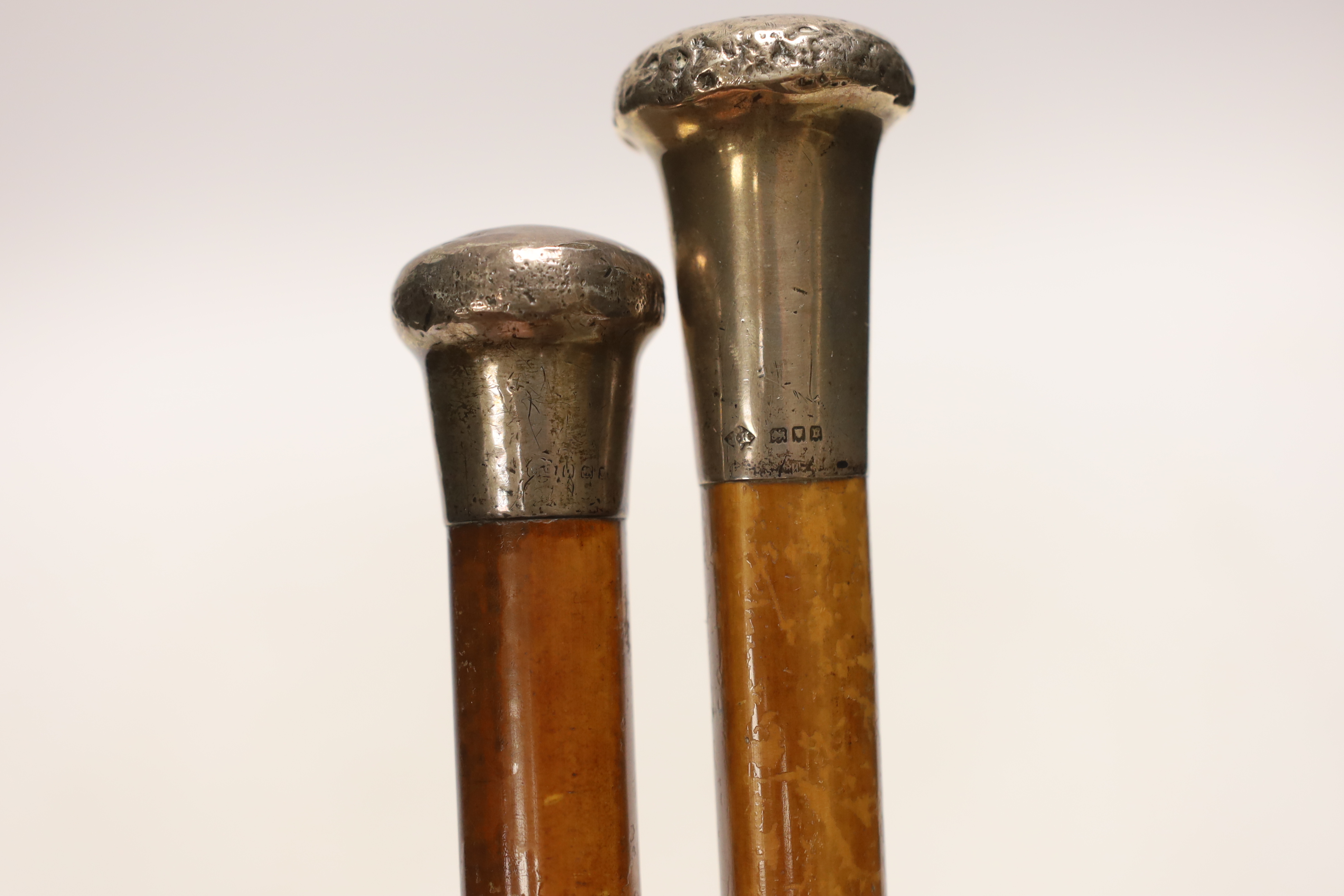 Four silver topped walking canes, one with antler handle